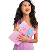 Tween holding a pink and blue clutch against a light blue background